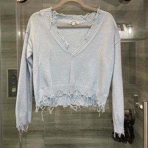 Shredded slightly cropped blue sweater
